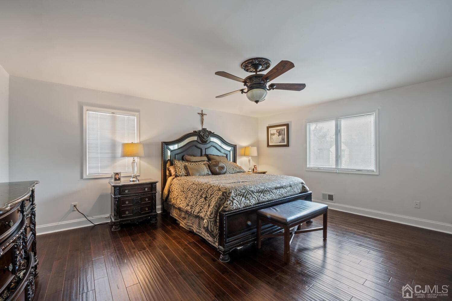 73 Appletree Road Howell, NJ 07731 - Photo 29 of 43 a bedroom with a bed a window and a chandelier