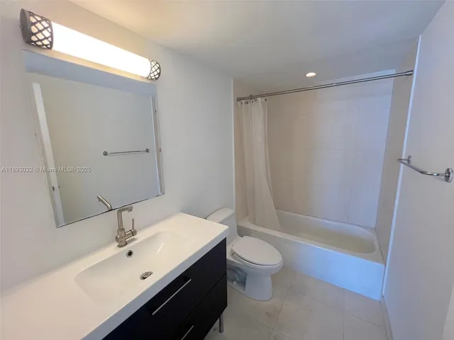 a bathroom with a sink mirror toilet and bathtub