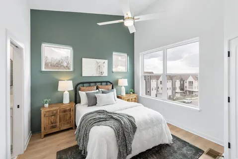 a bedroom with a large bed and a window
