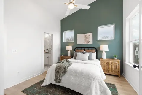 a bedroom with a bed and a chandelier