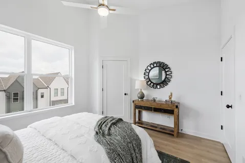 a bedroom with a bed and a chandelier