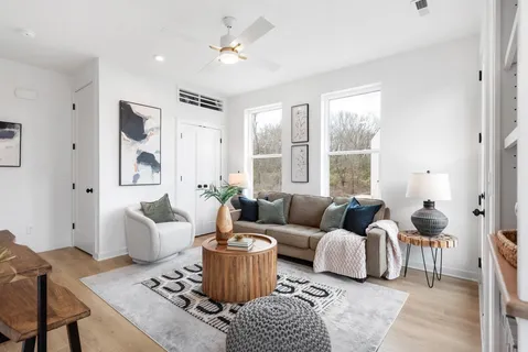 a living room with furniture and a large window