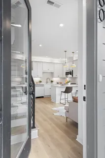a living room with stainless steel appliances kitchen island granite countertop furniture and a view of living room