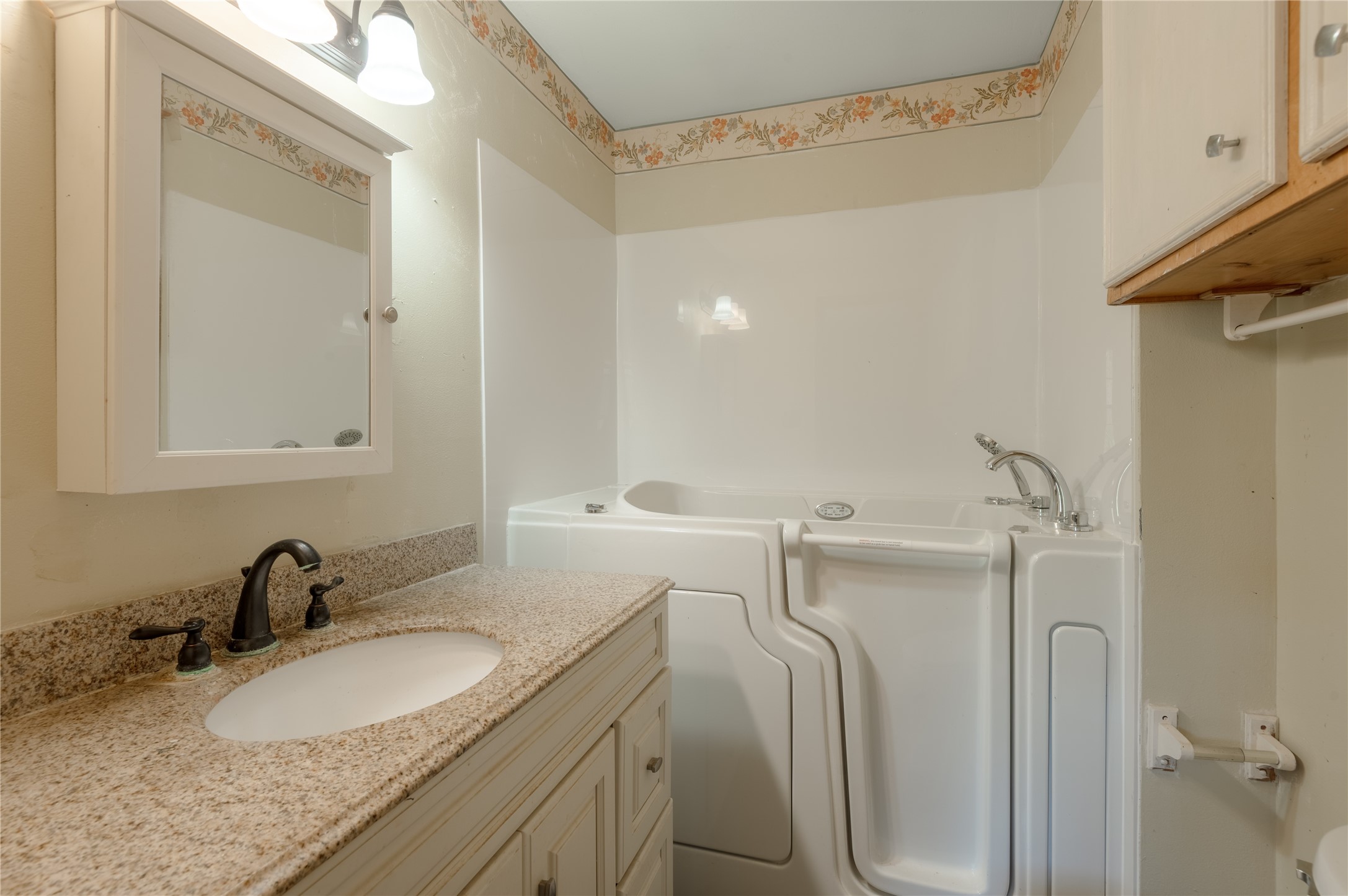 2792 Highway 287 Groveton, TX 75845 - Photo 12 of 25 a bathroom with a granite countertop sink and a mirror