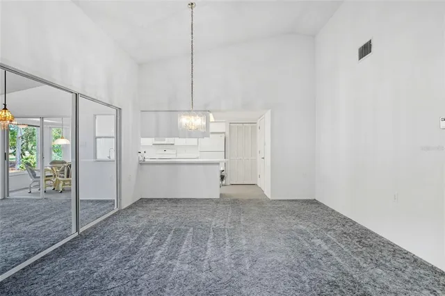 a view of a kitchen with a sink wooden cabinets and a window