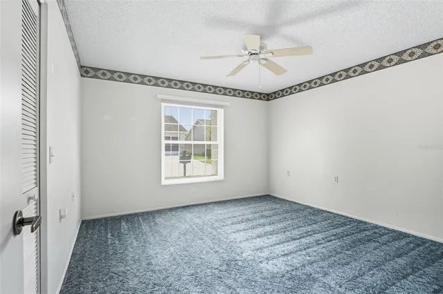 a view of a hallway with a chandelier fan and windows