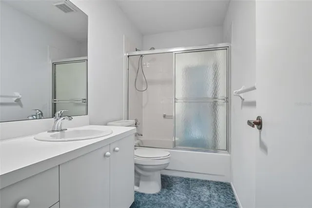 a bedroom with a bed table and a window