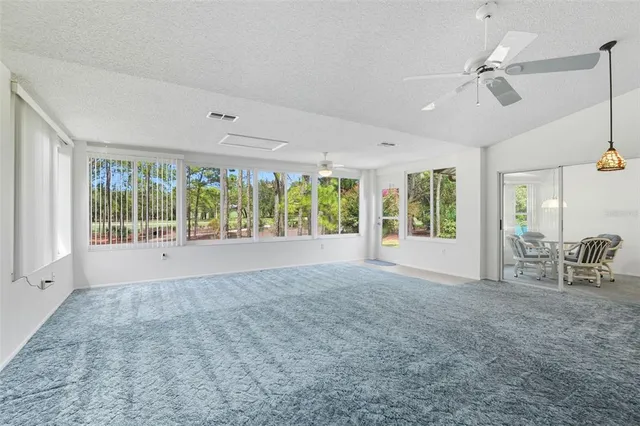 a view of a kitchen with a sink dishwasher a stove and a refrigerator with wooden cabinets