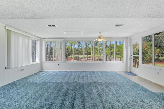 a large white kitchen with a large window and stainless steel appliances
