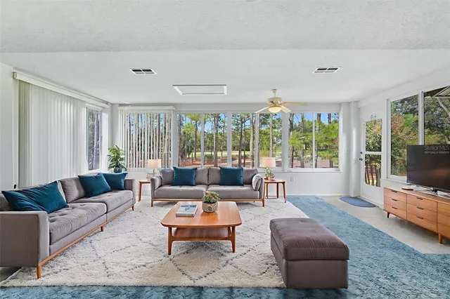 a kitchen with a sink a refrigerator and cabinets