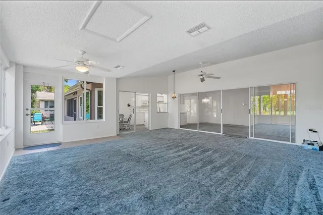 a dining room with furniture a chandelier and window
