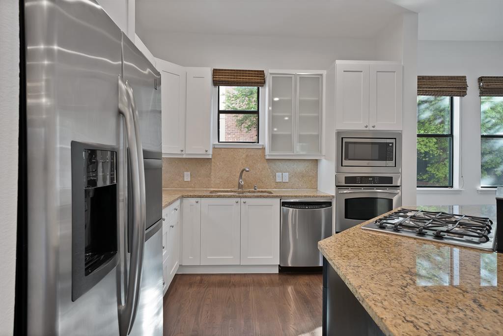 2420 Hugo Street, Unit 3 Dallas, TX 75204 - Photo 12 of 36 a kitchen with a stove a sink and a refrigerator