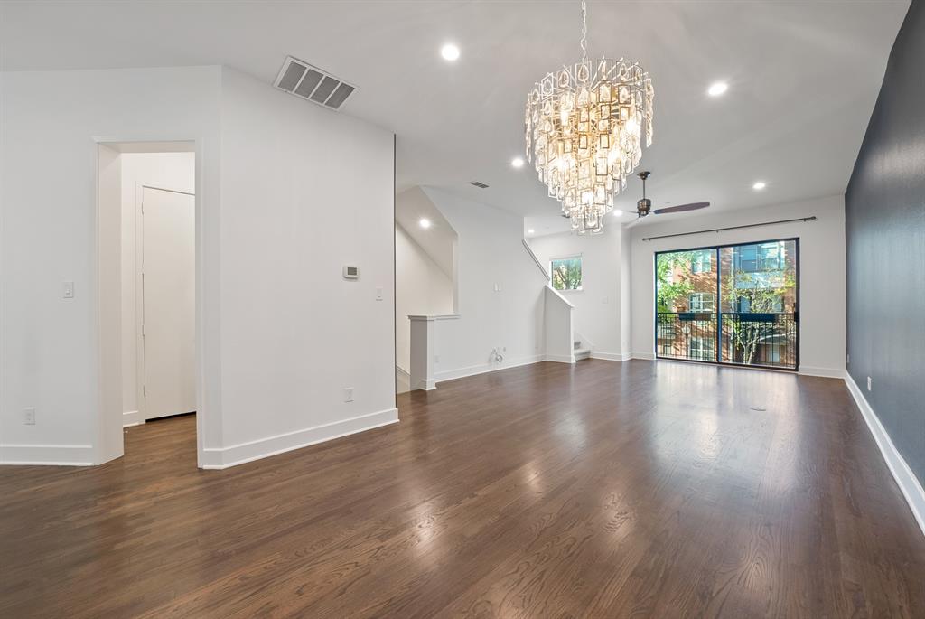 2420 Hugo Street, Unit 3 Dallas, TX 75204 - Photo 20 of 36 a view of an empty room with wooden floor and a large window
