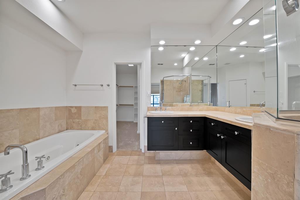 2420 Hugo Street, Unit 3 Dallas, TX 75204 - Photo 26 of 36 a bathroom with a bathtub sink and mirror