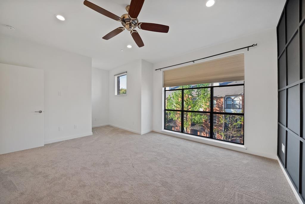 2420 Hugo Street, Unit 3 Dallas, TX 75204 - Photo 29 of 36 an empty room with ceiling fan and windows