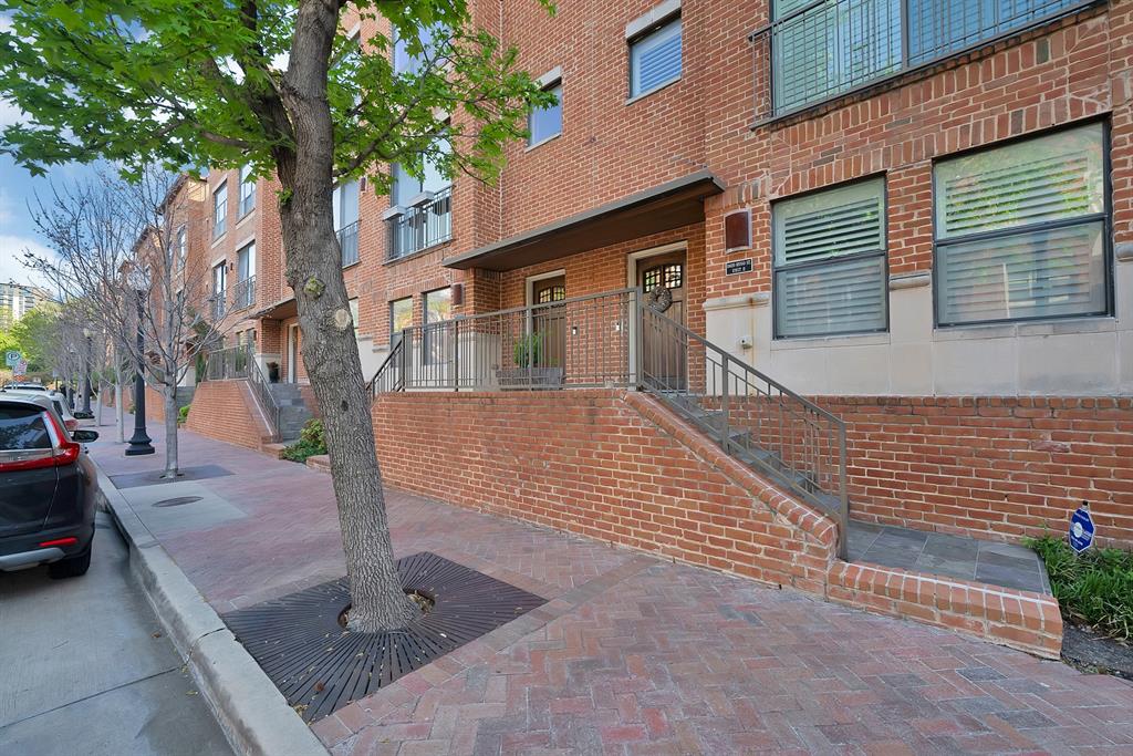 2420 Hugo Street, Unit 3 Dallas, TX 75204 - Photo 3 of 36 a front view of a house with a garden