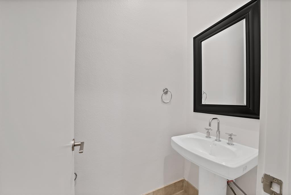 2420 Hugo Street, Unit 3 Dallas, TX 75204 - Photo 33 of 36 a bathroom with a sink and a mirror