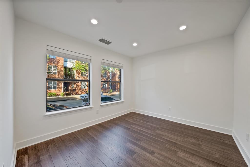2420 Hugo Street, Unit 3 Dallas, TX 75204 - Photo 10 of 36 an empty room with wooden floor and windows