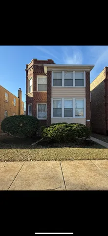 a view of front door and small yard
