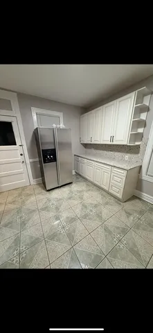 a view of kitchen with microwave stove and cabinets