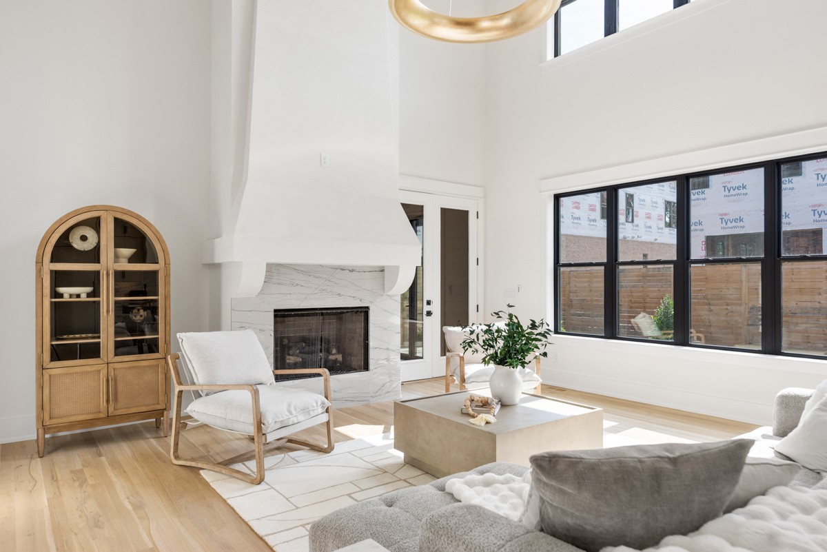 5619 Valley View Road Brentwood, TN 37027 - Photo 13 of 55 a living room with furniture a fireplace and a large window