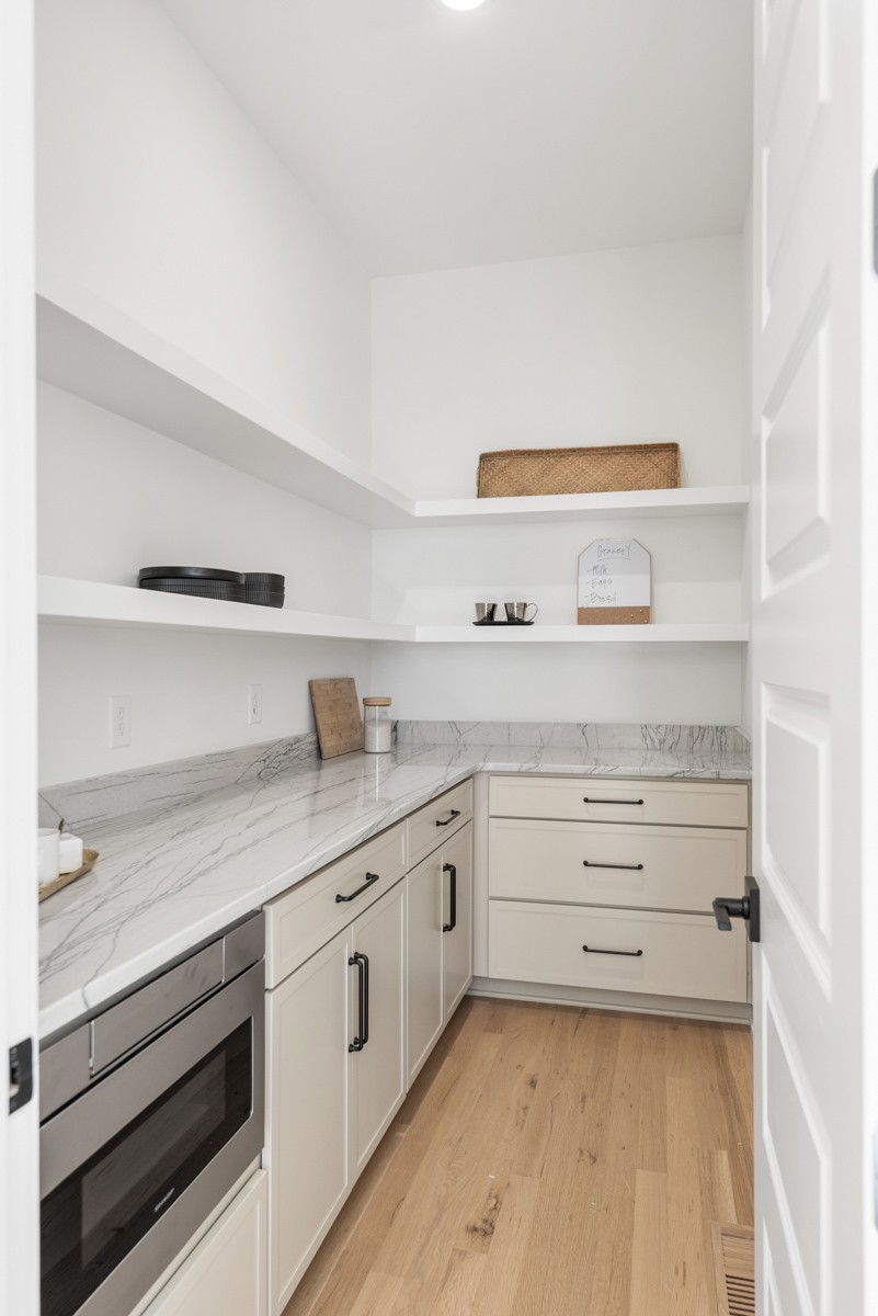 5619 Valley View Road Brentwood, TN 37027 - Photo 21 of 55 a kitchen with granite countertop white cabinets and white appliances