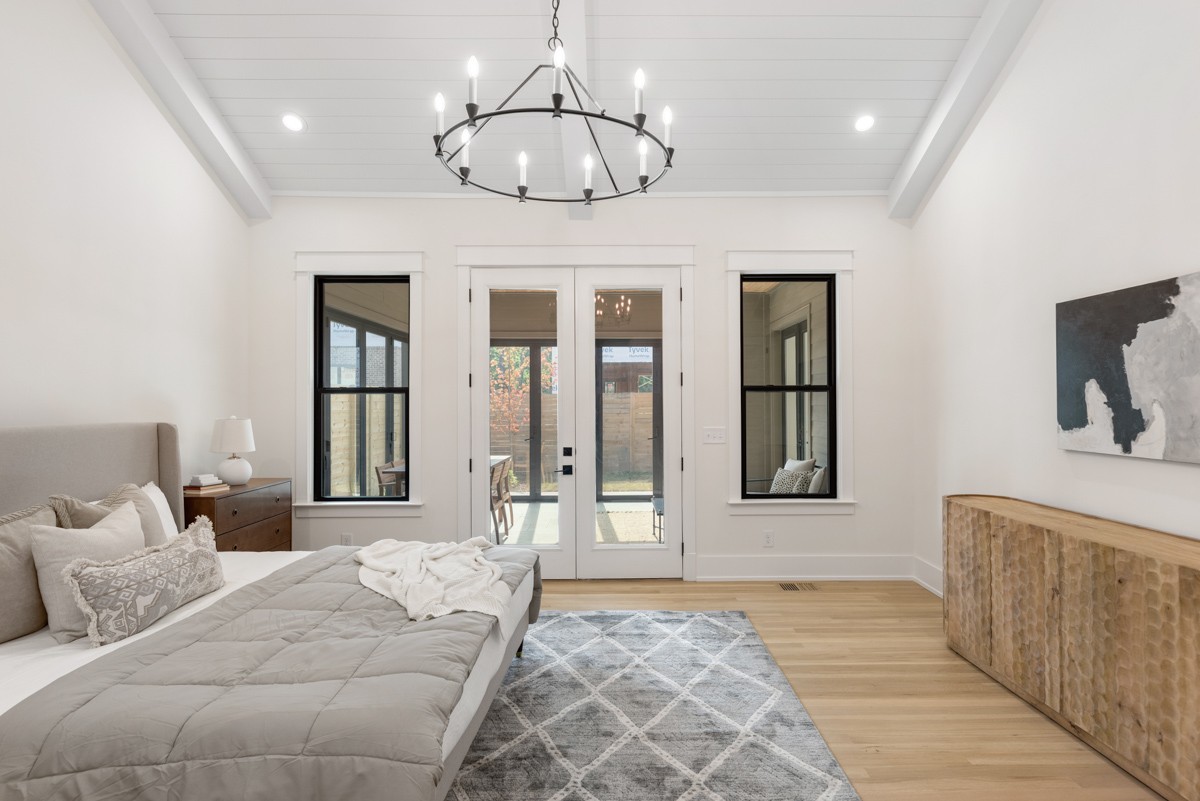 5619 Valley View Road Brentwood, TN 37027 - Photo 26 of 55 a bedroom with a large bed and a chandelier