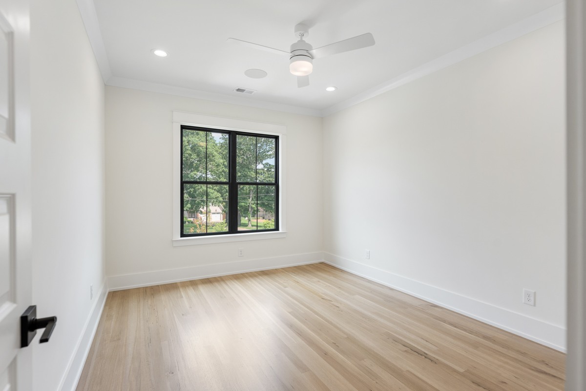 5619 Valley View Road Brentwood, TN 37027 - Photo 42 of 55 an empty room with wooden floor chandelier fan and windows