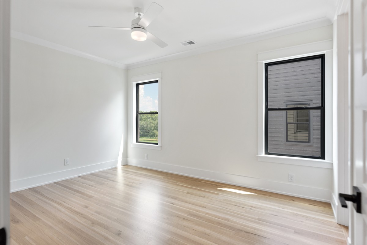 5619 Valley View Road Brentwood, TN 37027 - Photo 43 of 55 an empty room with wooden floor and windows