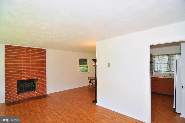 5729 Oakland Road Halethorpe, MD 21227 - Photo 5 of 18 a view of a livingroom with wooden floor and a fireplace