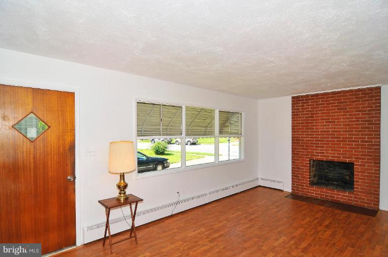 5729 Oakland Road Halethorpe, MD 21227 - Photo 9 of 18 a view of an empty room with a fireplace and a window