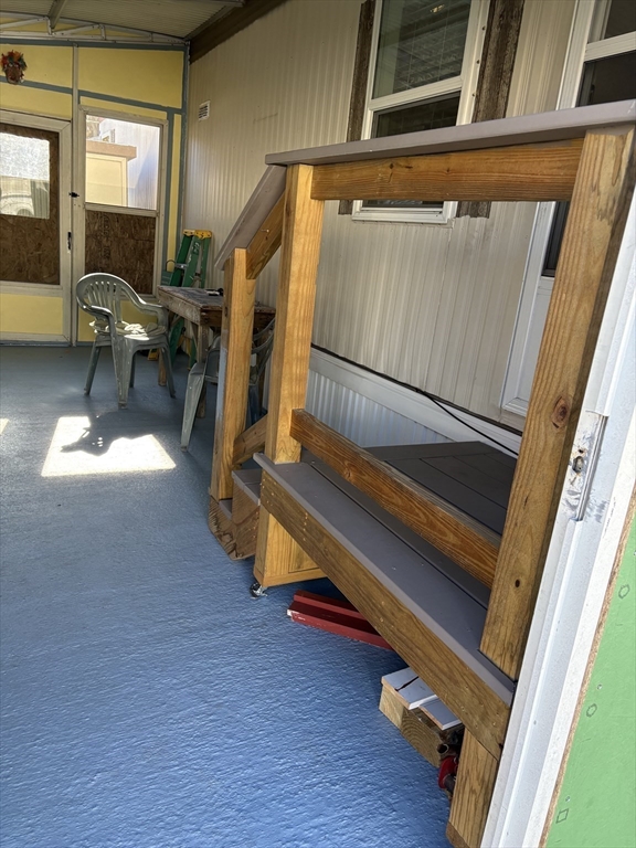 557 Southwest Cutoff, Unit 17 Worcester, MA 01607 - Photo 15 of 19 a view of deck with wooden floor and chair