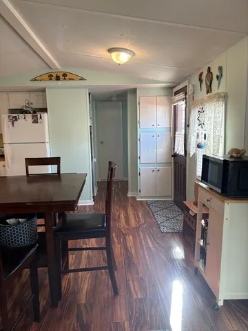 a view of a workspace with furniture and wooden floor
