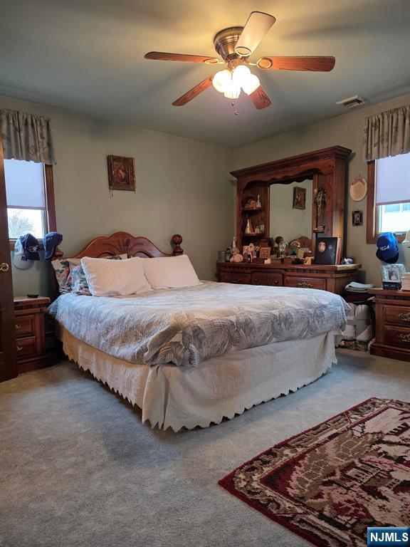 214 Newark Avenue, Unit 2 Lyndhurst, NJ 07071 - Photo 12 of 13 a bedroom with bed and a chandelier
