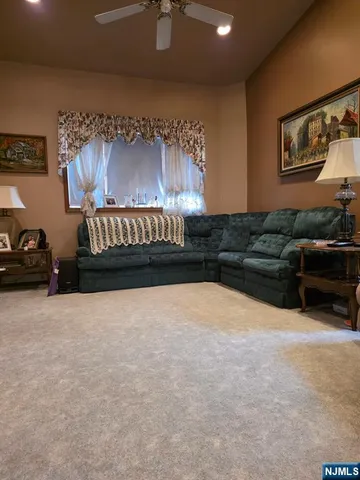 a living room with furniture window and wall painting