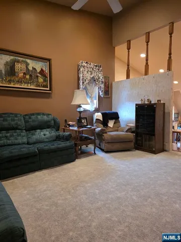a living room with furniture a large window and a fireplace