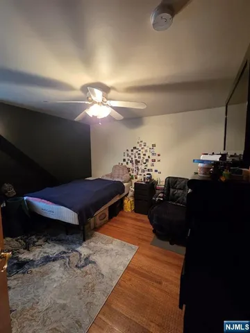 a living room with furniture a lamp and a rug