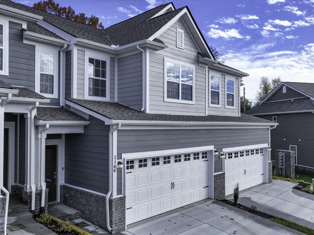 a front view of a house with a garage