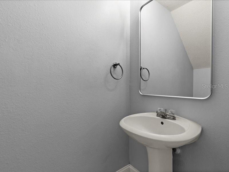 29924 Playa Del Rey Lane Wesley Chapel, FL 33543 - Photo 20 of 31 a bathroom with a sink and mirror