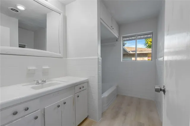 a bathroom with a sink a vanity and a mirror