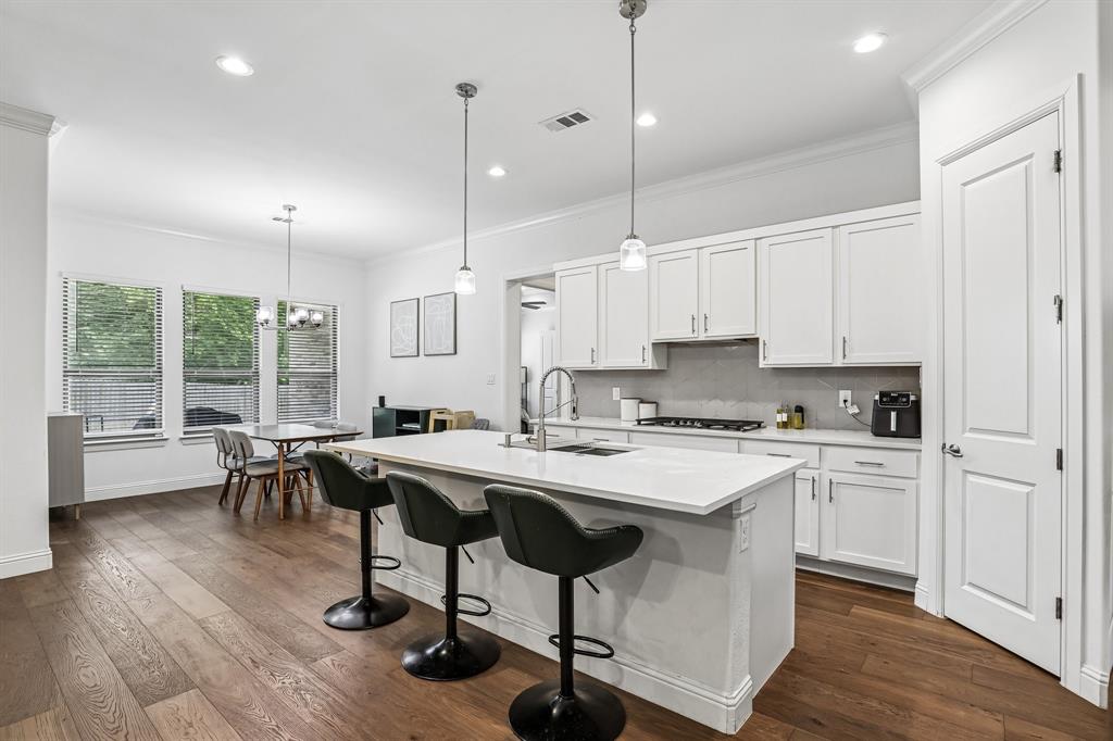 515 West Laureland Road Dallas, TX 75232 - Photo 8 of 32 a kitchen with a table chairs stove and wooden floor