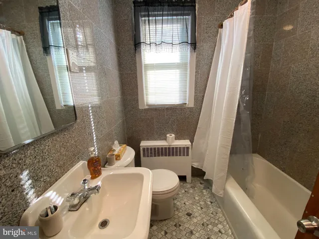 a bath room with a sink and a bath tub