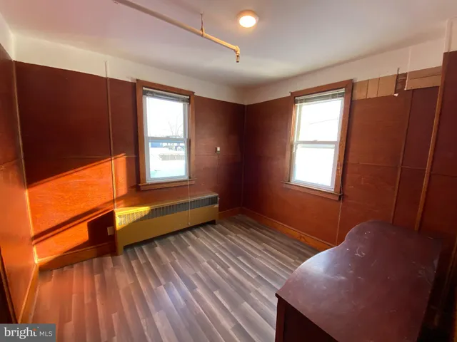 a view of room with window and wooden floor