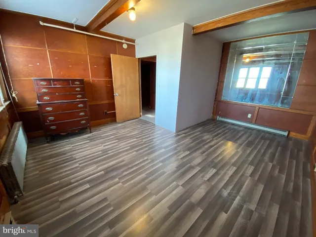 a view of room with window and wooden floor