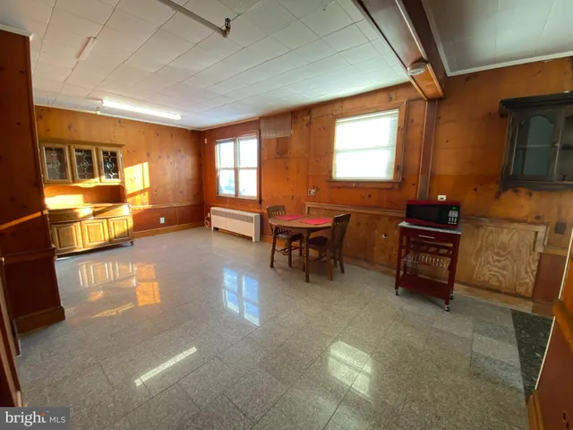 a living room with furniture and a piano