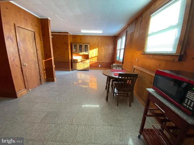 a dining room with furniture and a window