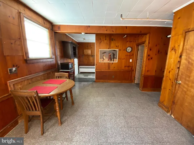 a living room with furniture a rug and a window