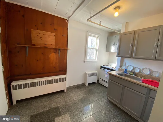 a bathroom with a window sink and mirror