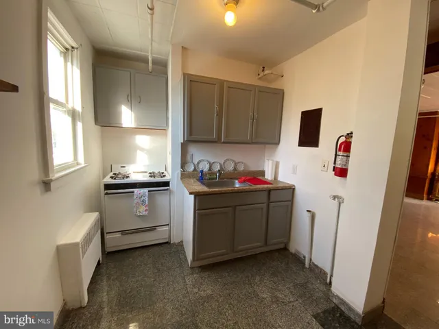 a kitchen with sink refrigerator and window