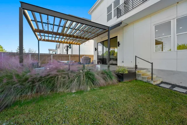 a roof deck with couches and umbrella